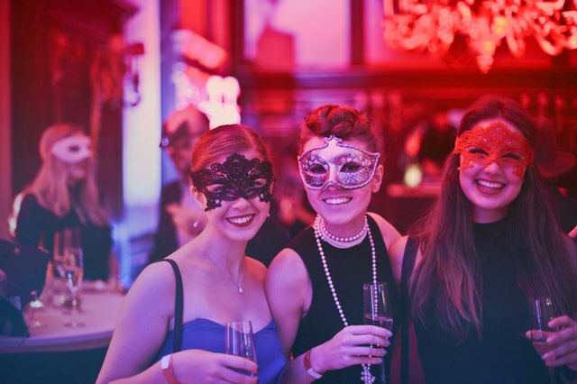 photo-of-women-wearing-masks-at-a-bar-event